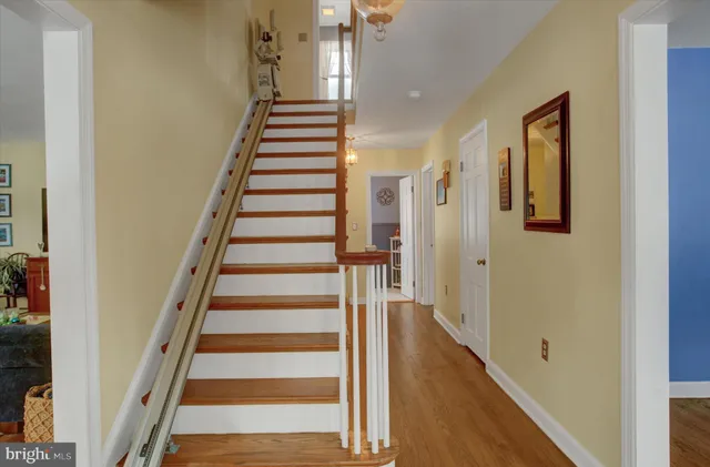 a view of a hallway with wooden floor and entryway