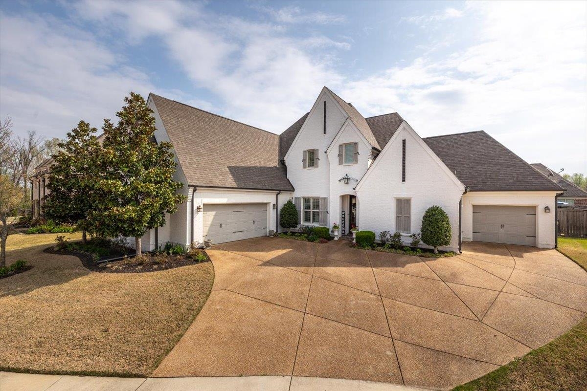 608 Cypress Run Cove Collierville, TN 38017 - Photo 1 of 40 French country home with a garage, roof with shingles, concrete driveway, and brick siding