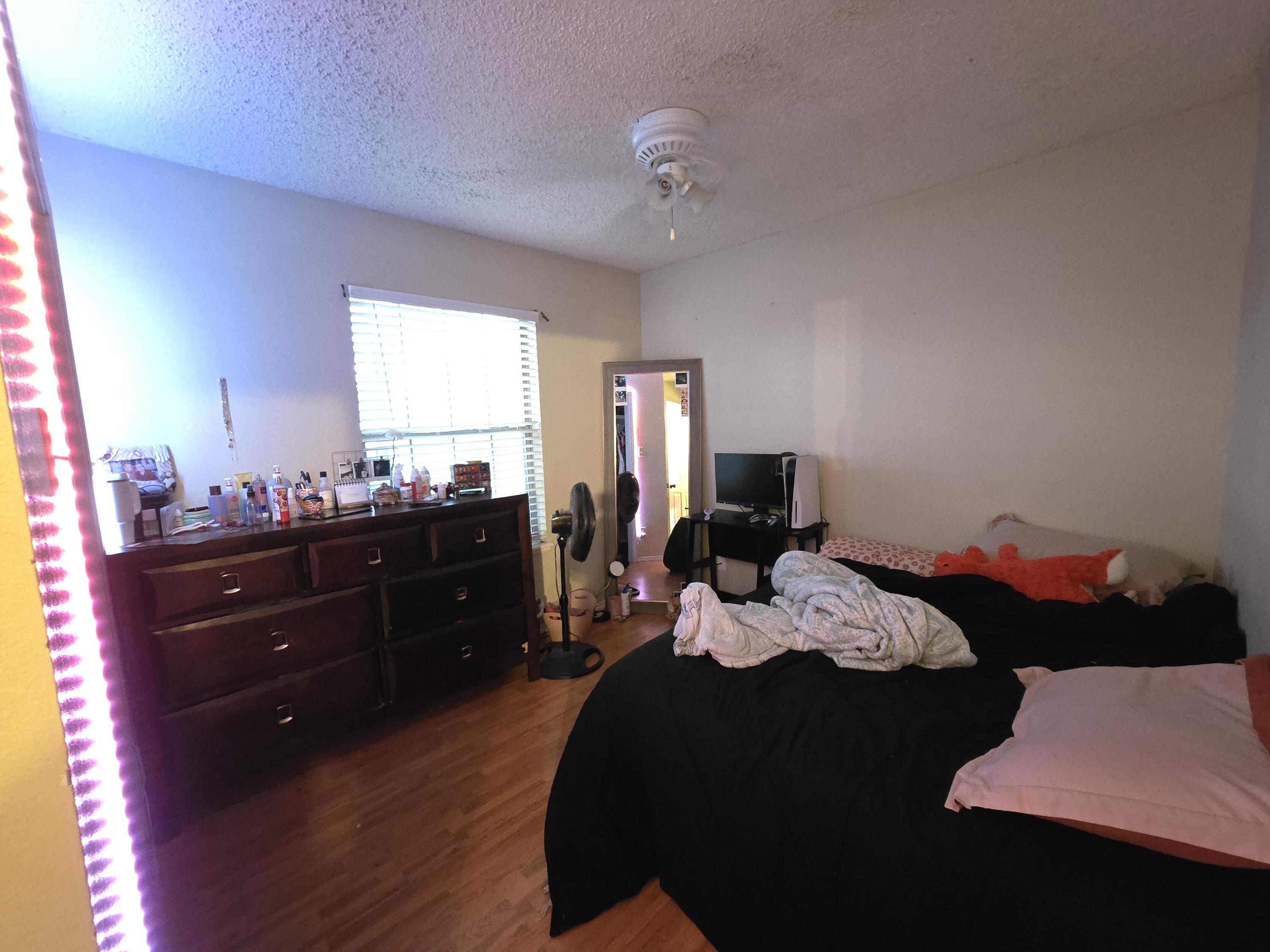 5806 12th Street Lubbock, TX 79416 - Photo 14 of 17 a bed room with a bed and a dresser