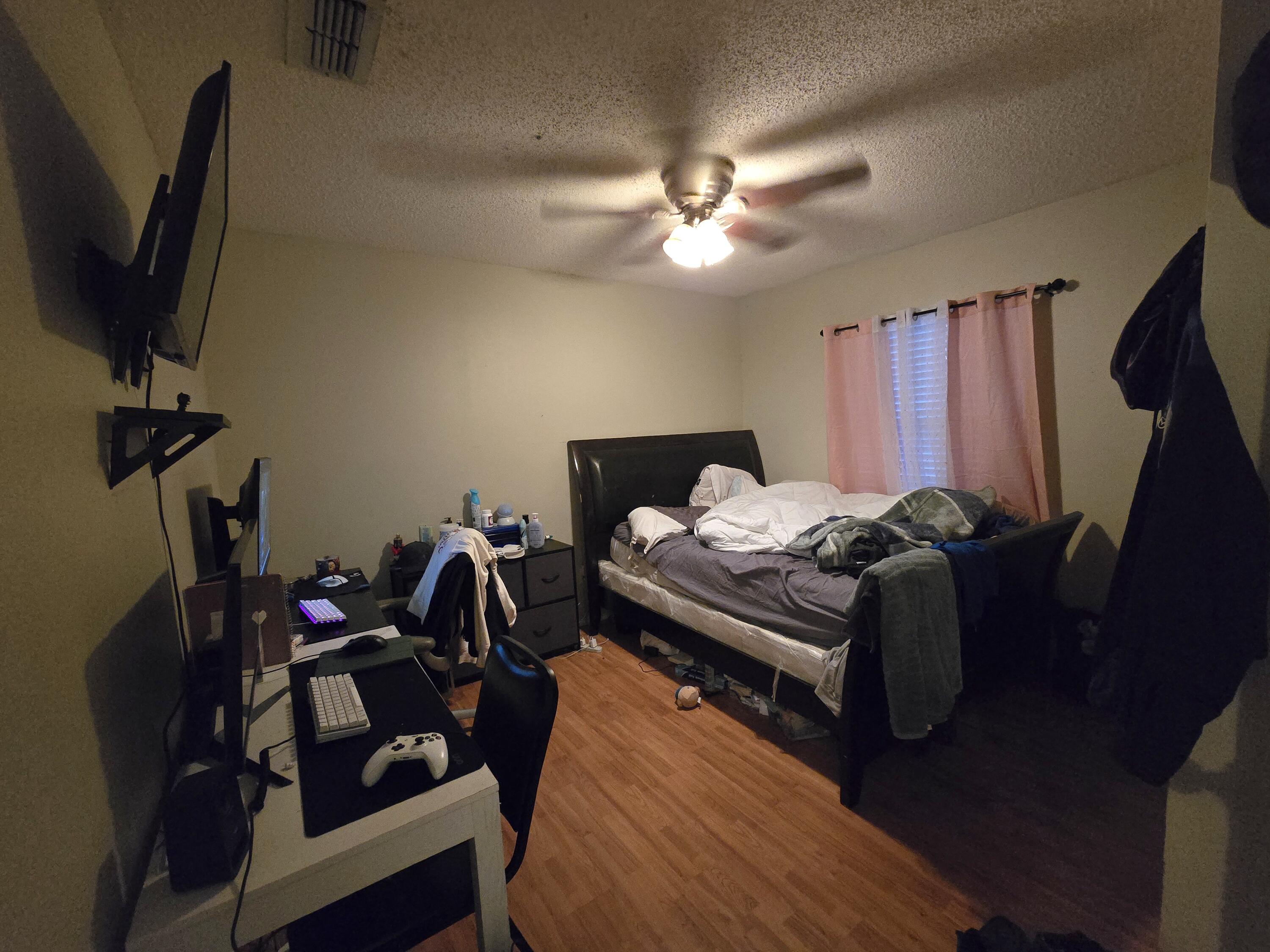 5806 12th Street Lubbock, TX 79416 - Photo 15 of 17 a bed room with a bed window and a mirror