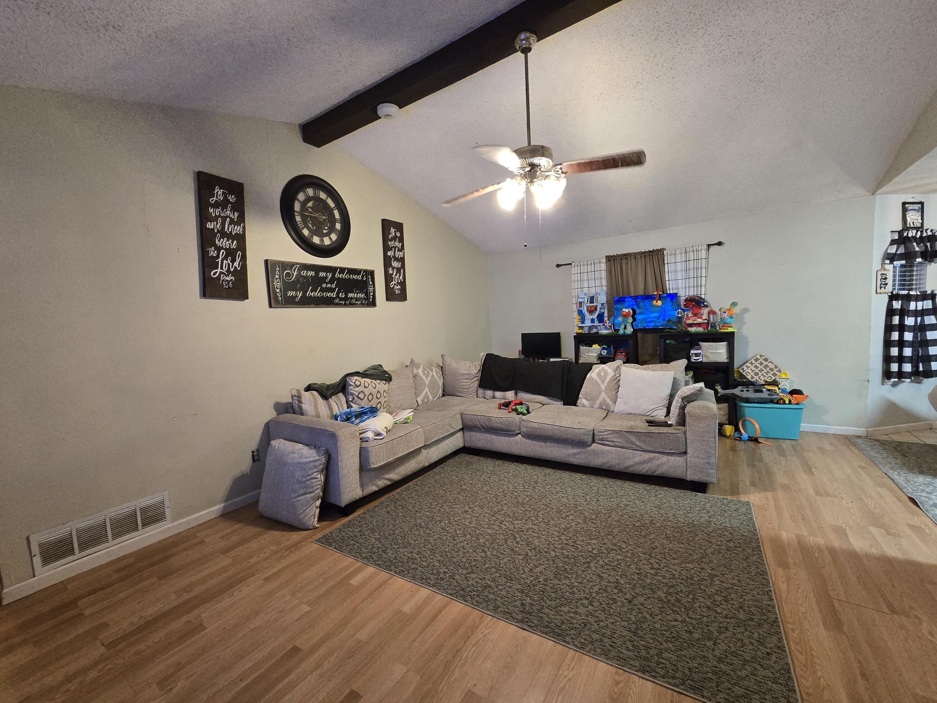 5806 12th Street Lubbock, TX 79416 - Photo 2 of 17 a living room with furniture and a flat screen tv