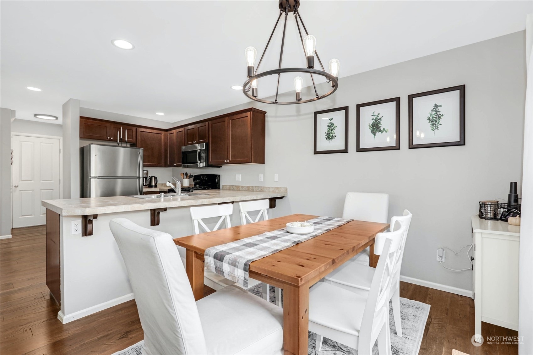 15 194th Street Southwest Bothell, WA 98012 - Photo 13 of 27 a view of a dining room with furniture a chandelier and wooden floor