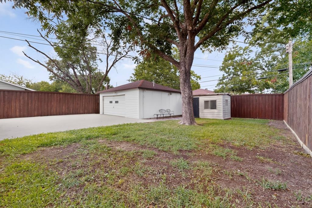 4404 Astor Road Mesquite, TX 75150 - Photo 36 of 38 Spacious backyard featuring a detached garage, a storage shed, and a large tree