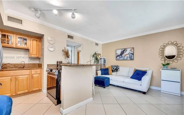 a living room with furniture and a kitchen
