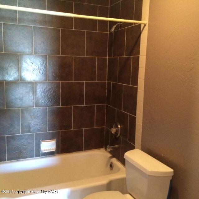 3704 South Harrison Street Amarillo, TX 79110 - Photo 8 of 13 a bathroom with a toilet and a bathtub