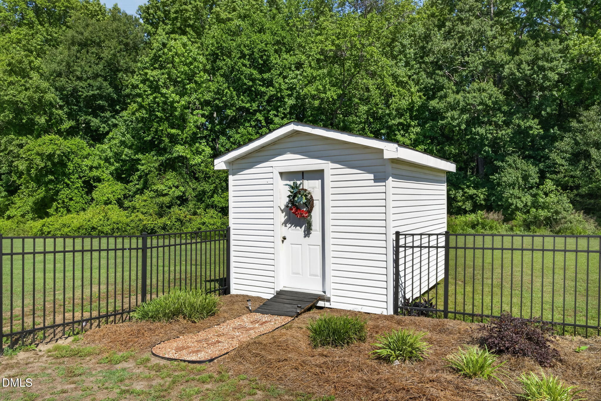 923 White Memorial Church Road Willow Spring, NC 27592 - Photo 36 of 46 a front view of a house with a garden