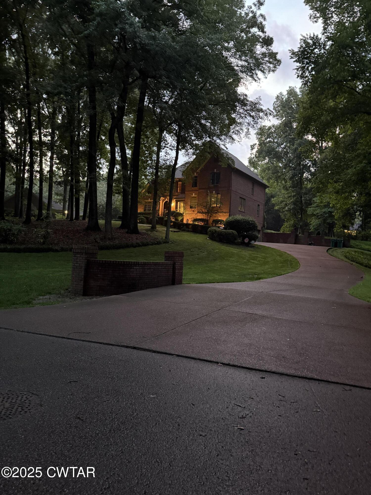 25 Whitfield Cove Jackson, TN 38305 - Photo 35 of 35 a front view of a house with a garden and trees