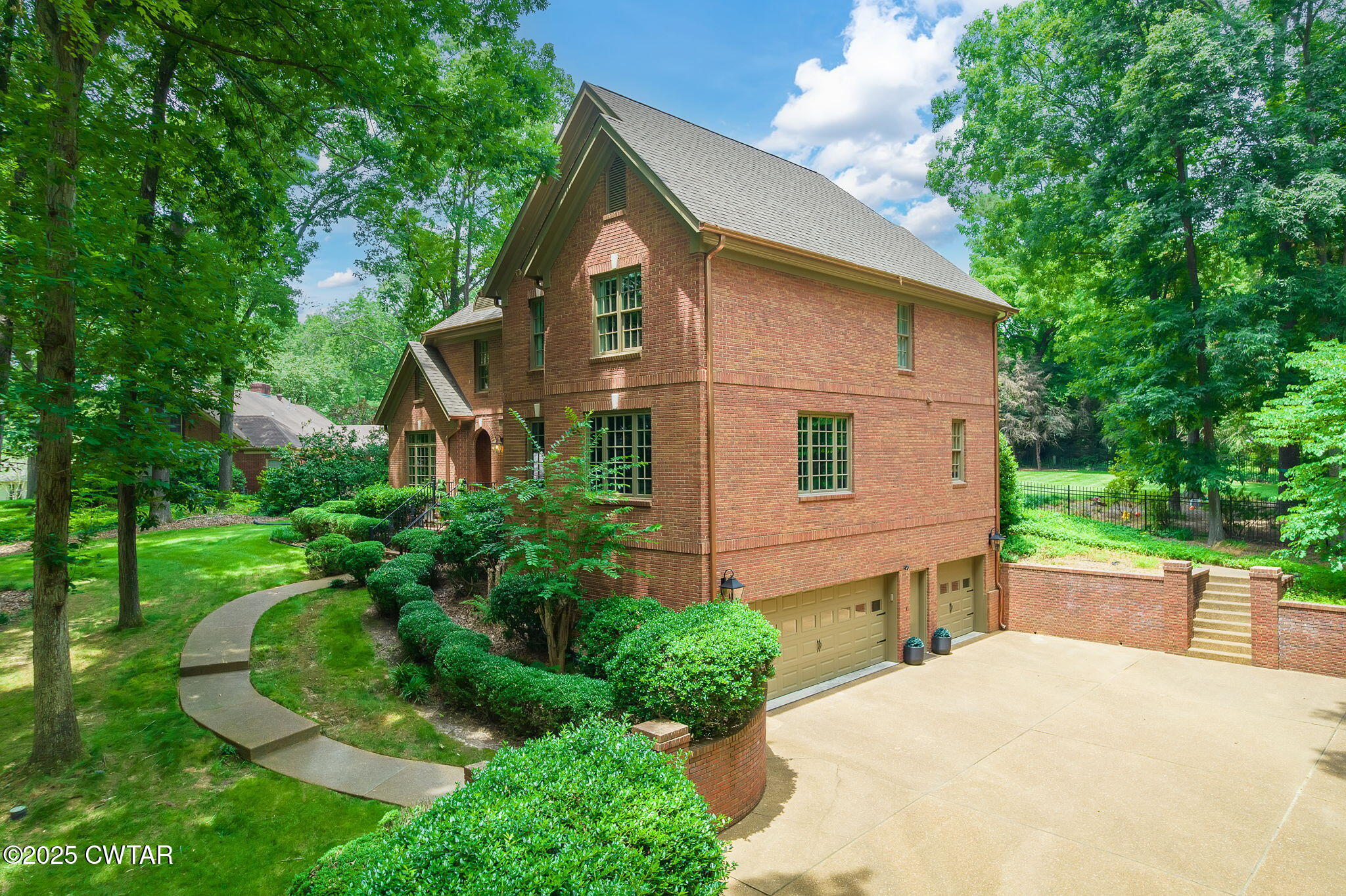25 Whitfield Cove Jackson, TN 38305 - Photo 5 of 35 a front view of a house with a yard and trees