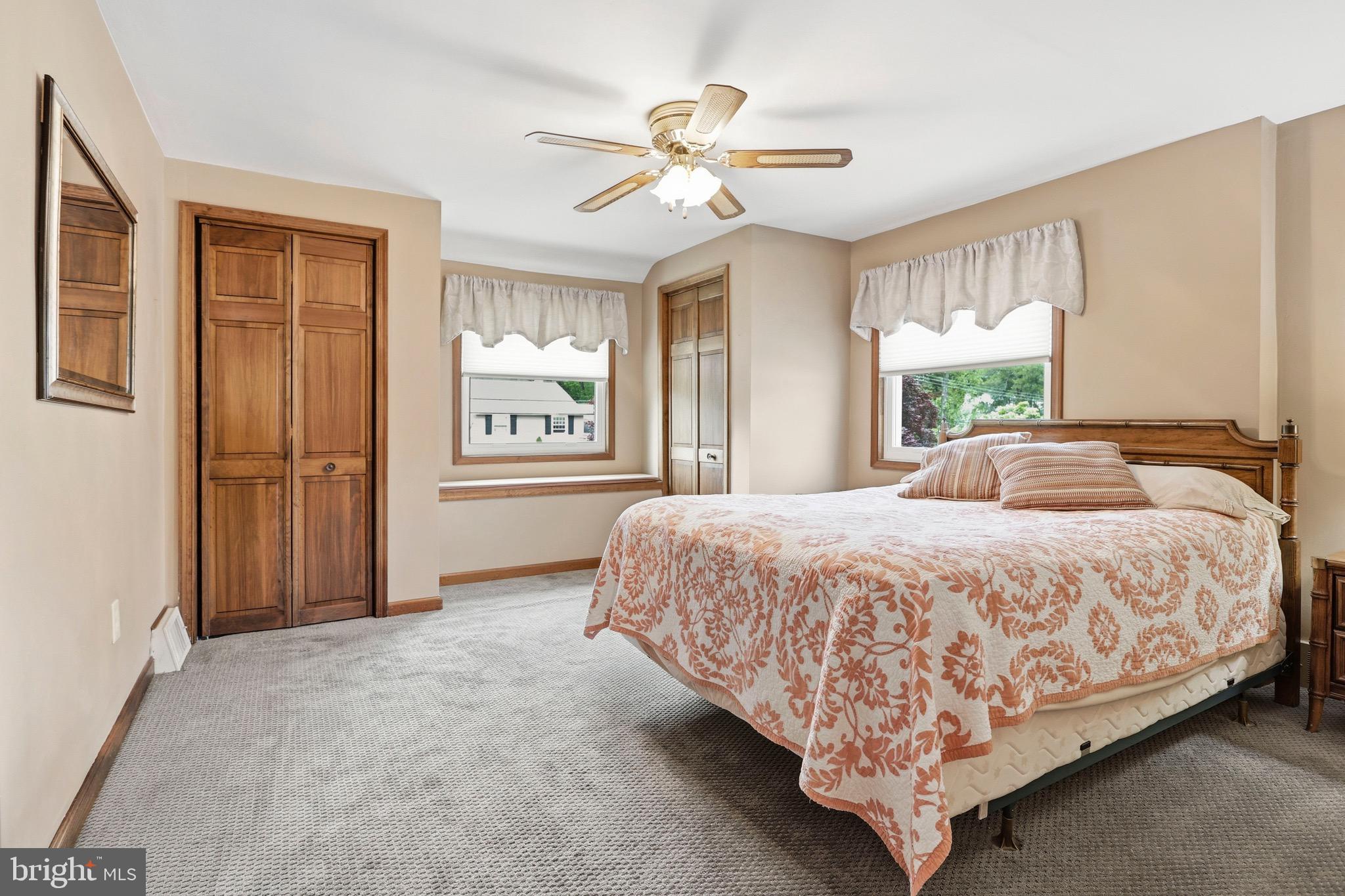 527 Saxer Avenue Springfield, PA 19064 - Photo 19 of 33 a spacious bedroom with a large bed chandelier and windows