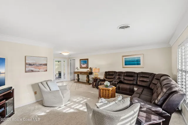 a living room with furniture a couch and a window
