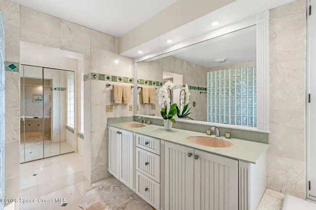 a spacious bathroom with a shower sink and mirror