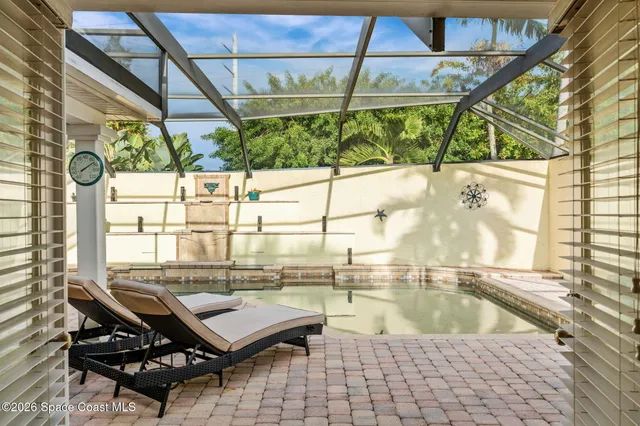 a view of a patio with couches chairs and a umbrella