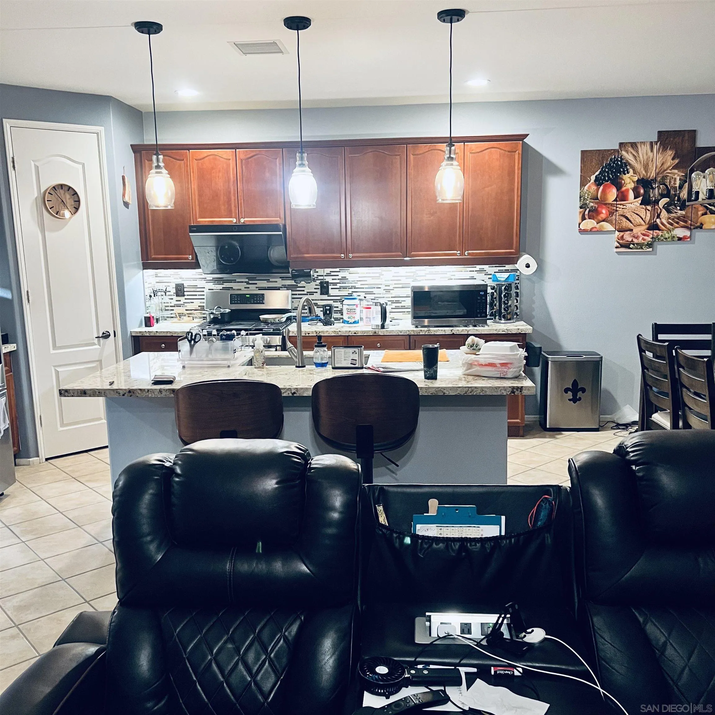 44482 Avenida Suarez Indio, CA 92201 - Photo 5 of 12 a kitchen with a refrigerator a stove a sink dishwasher a dining table and chairs with wooden floor