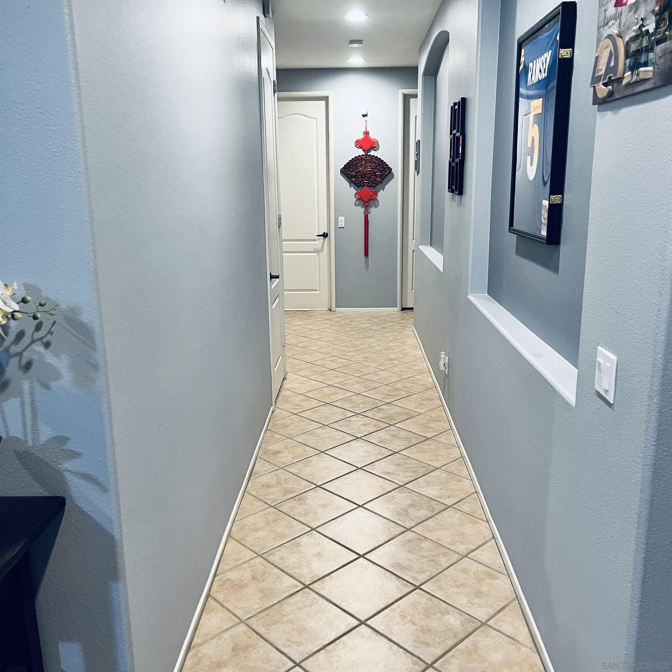 44482 Avenida Suarez Indio, CA 92201 - Photo 6 of 12 a hallway with beautiful frames and flower vase