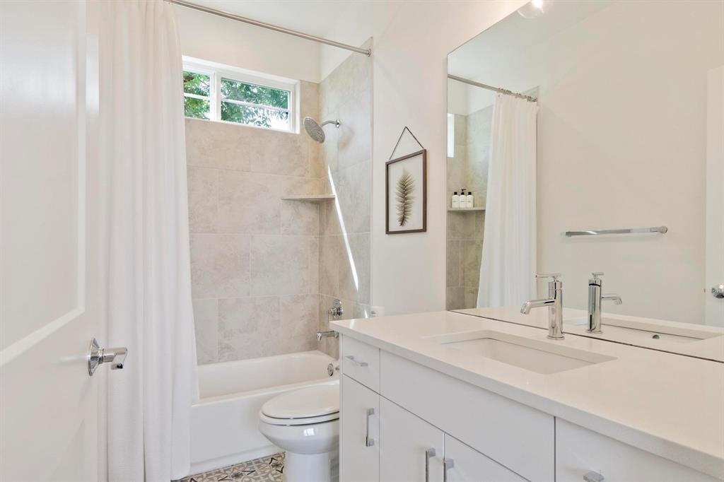 911 Stobaugh Street, Unit 2 Austin, TX 78757 - Photo 20 of 26 Bathroom featuring a white vanity with integrated sink, chrome faucet, and a large wall mirror