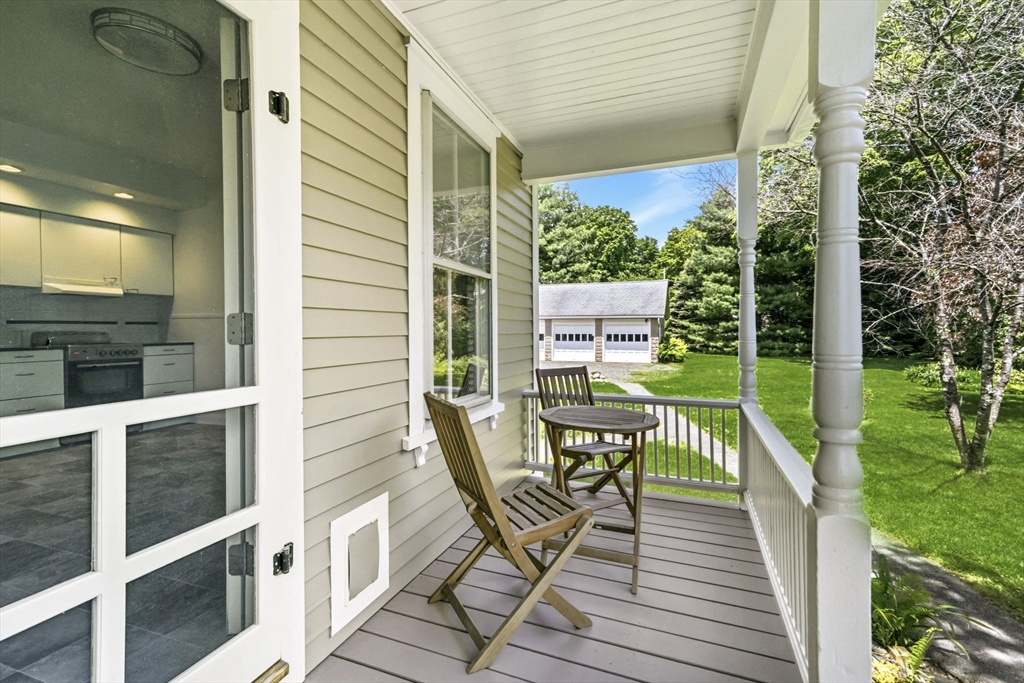 58 Front Street Northampton, MA 01053 - Photo 7 of 42 a view of a balcony with chairs and wooden fence
