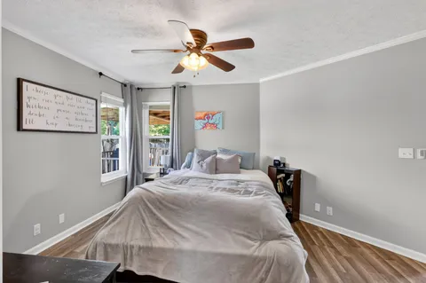 a bed sitting in a bedroom next to a window