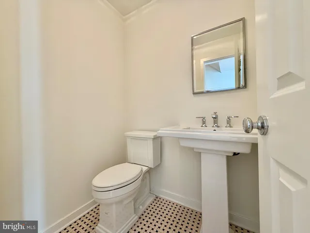 a bathroom with a sink toilet and mirror