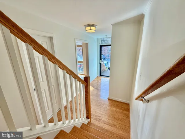 a view of staircase with railing and white walls