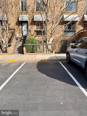 a view of a street with a cars parked in front of it