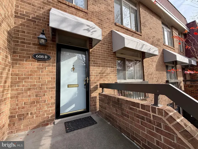 a view of a brick house with large windows