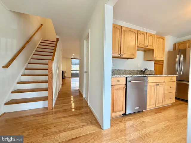 a view of a kitchen with stove and refrigerator