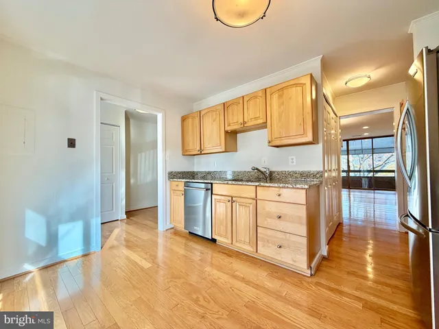 a spacious bathroom with a granite countertop sink and a mirror