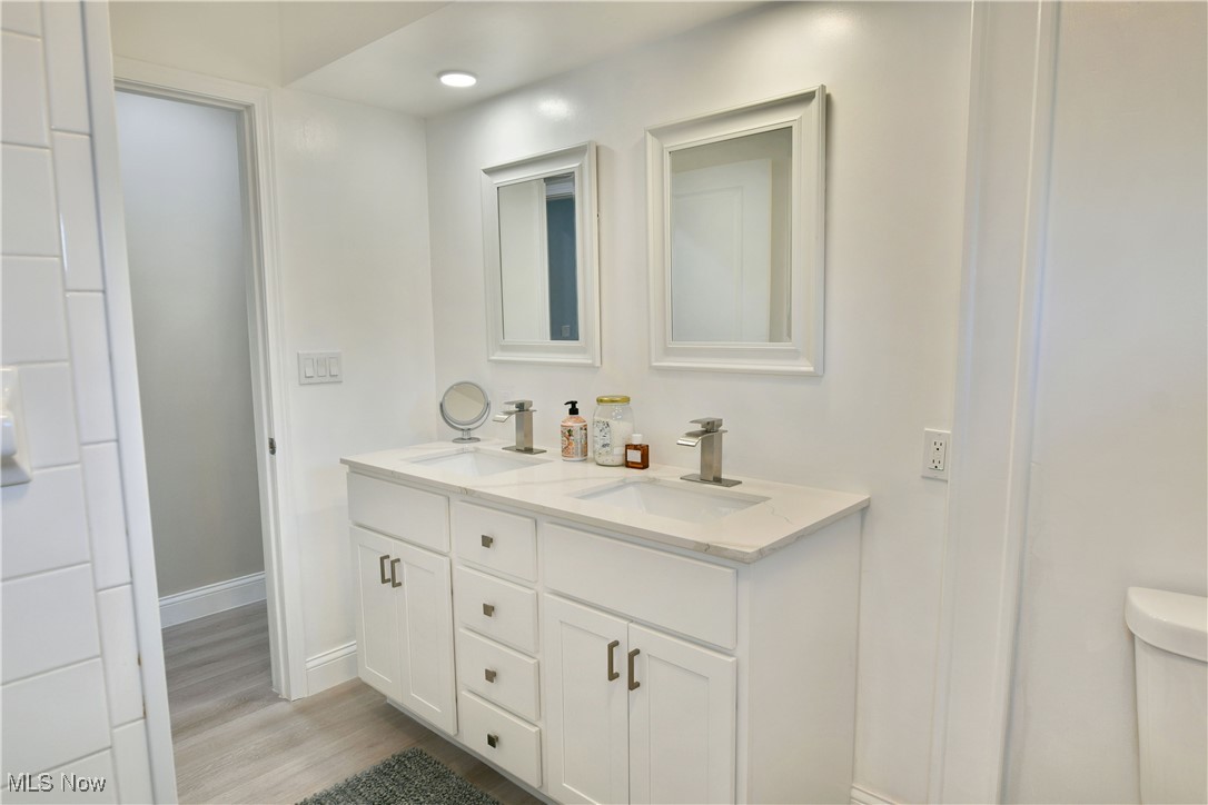 9633 Howland Springs Road Southeast Warren, OH 44484 - Photo 39 of 50 Bathroom featuring double vanity and light wood-type flooring