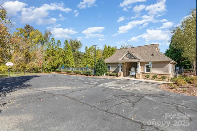a front view of a house with a yard and trees