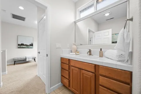 a bathroom with double vanity sink and a mirror