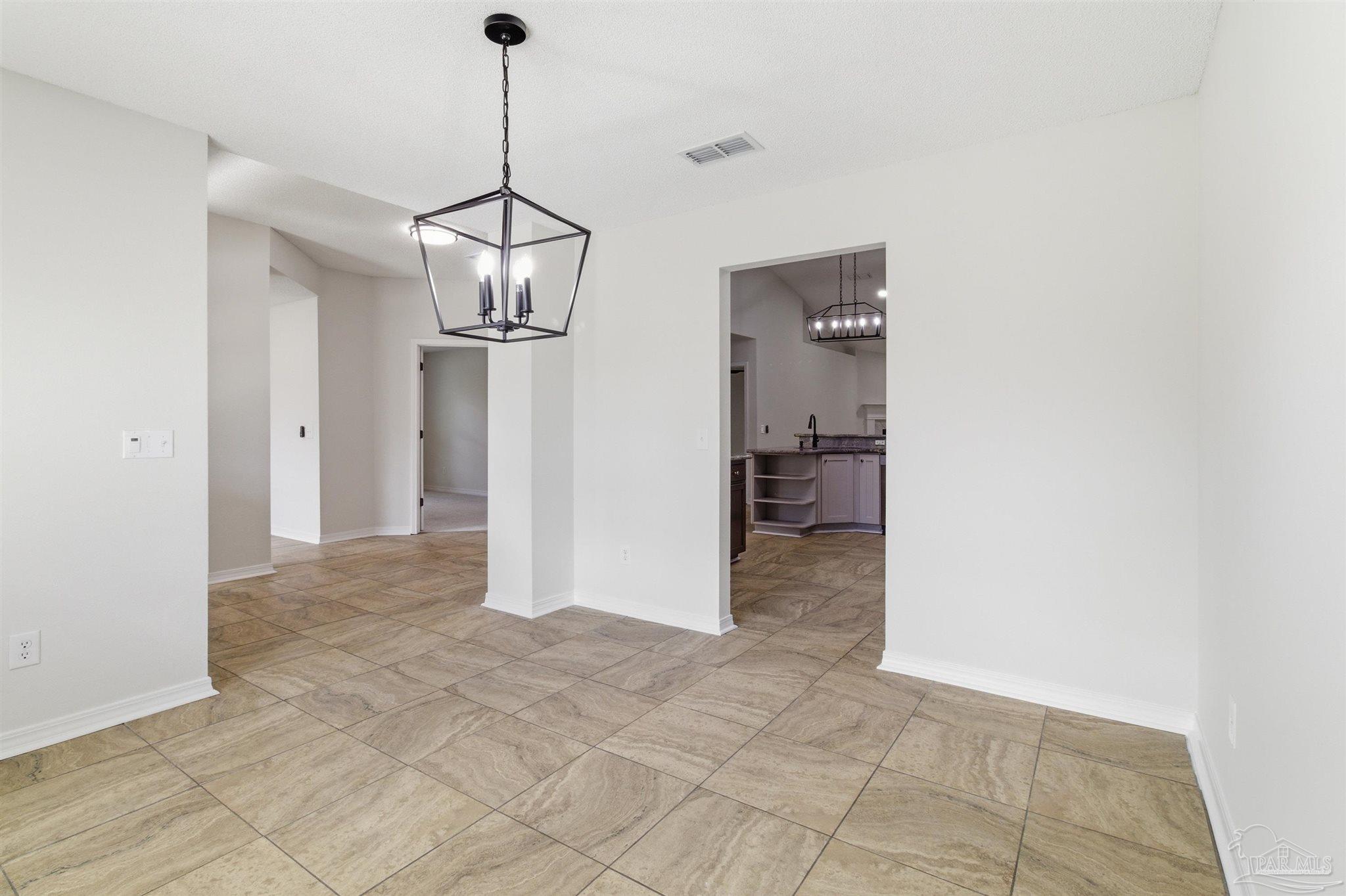 1866 Wareham Way Cantonment, FL 32533 - Photo 11 of 33 a view of a kitchen with a refrigerator and cabinets