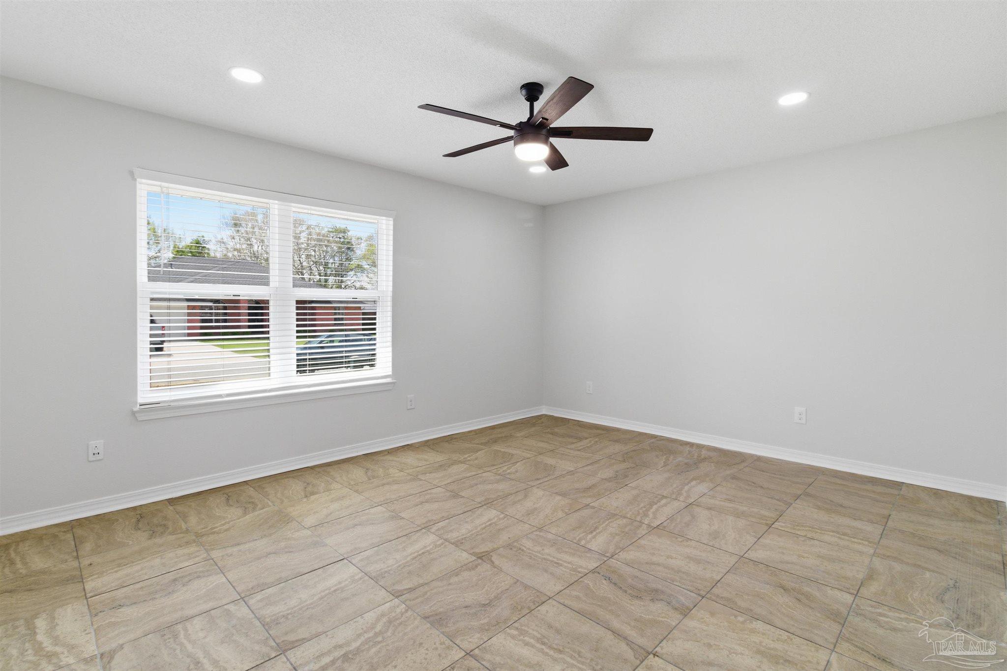 1866 Wareham Way Cantonment, FL 32533 - Photo 16 of 33 an empty room with windows and fan
