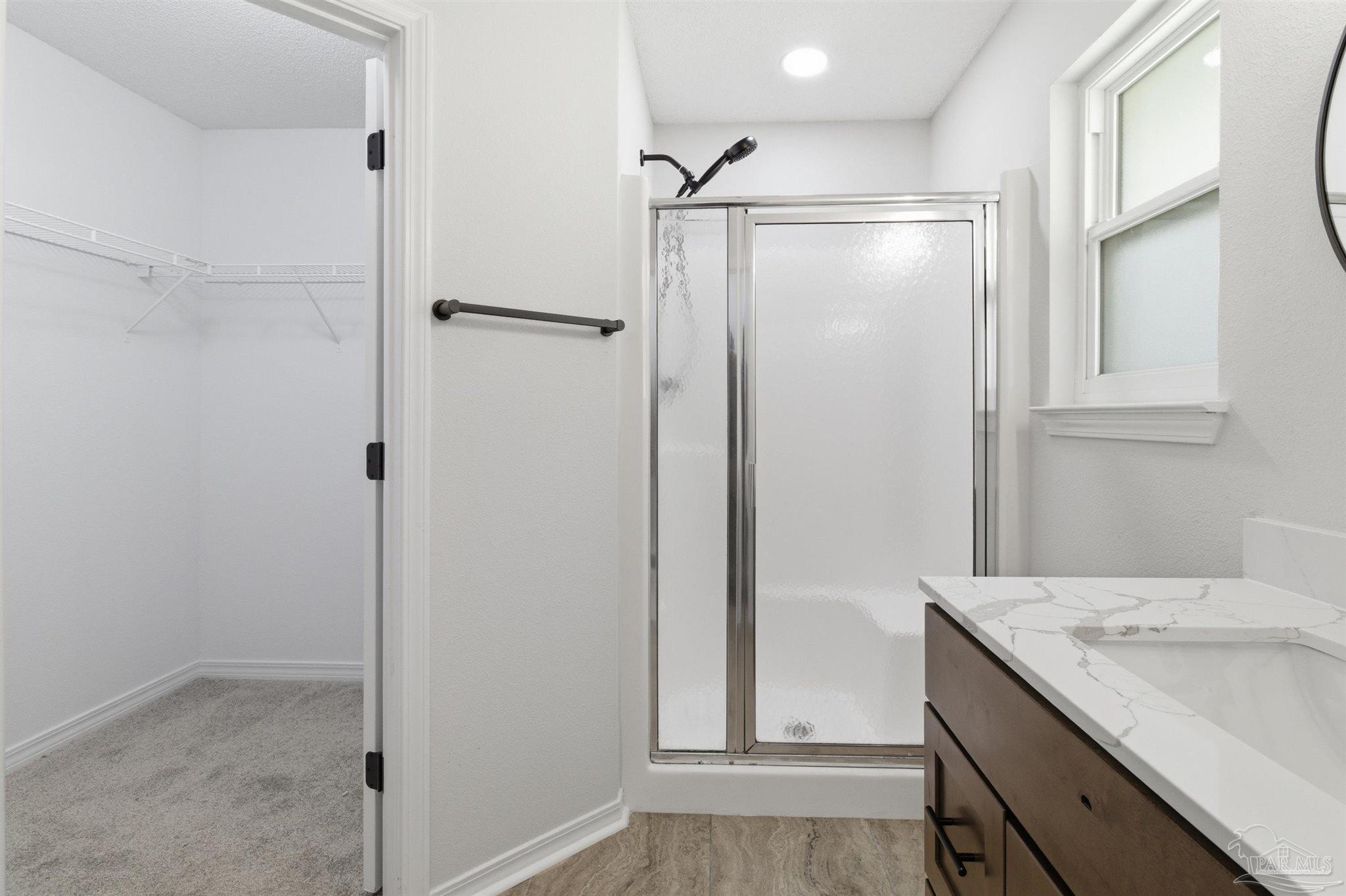 1866 Wareham Way Cantonment, FL 32533 - Photo 18 of 33 a bathroom with a shower sink and vanity