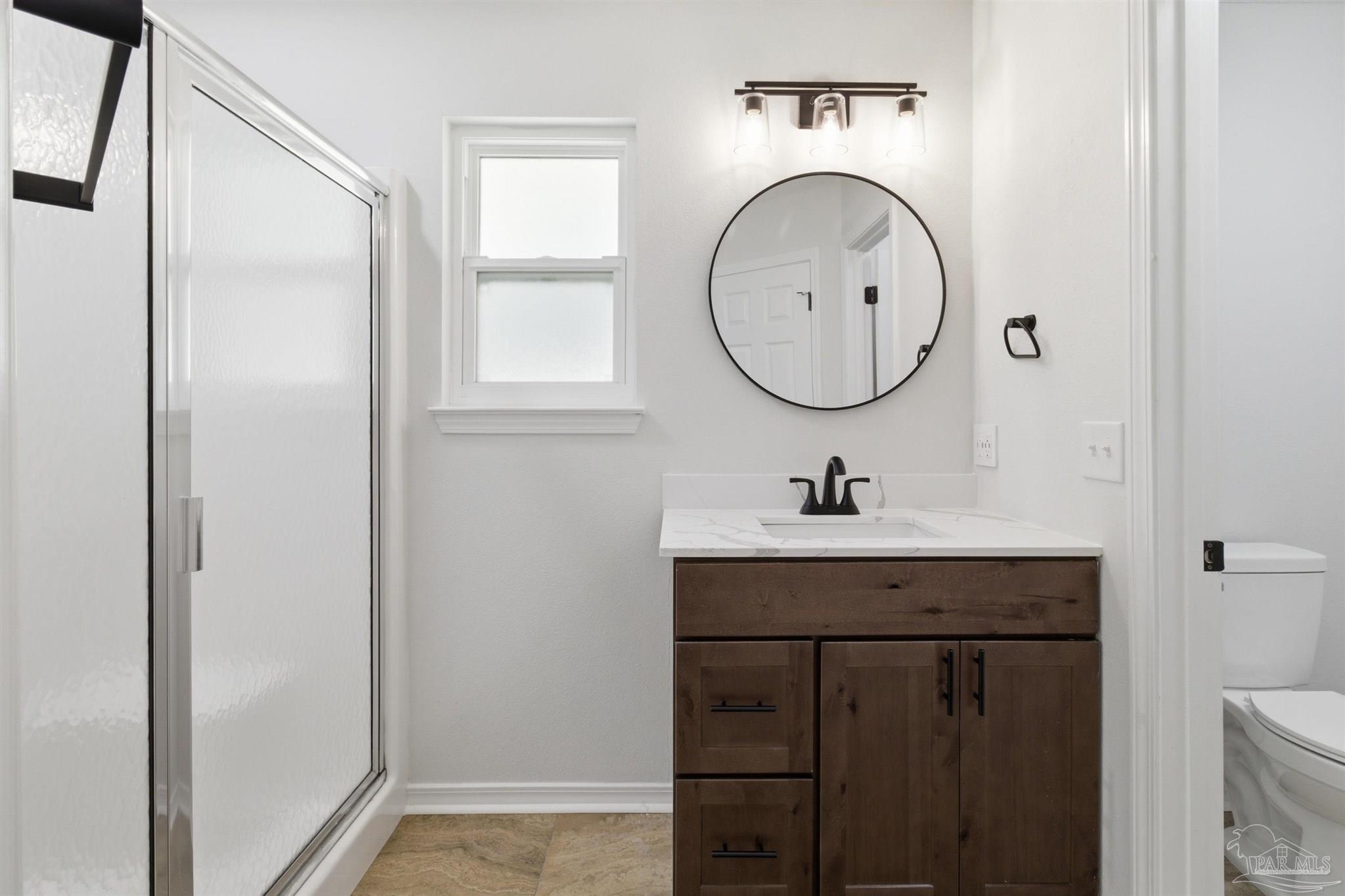 1866 Wareham Way Cantonment, FL 32533 - Photo 19 of 33 a bathroom with a sink and a mirror