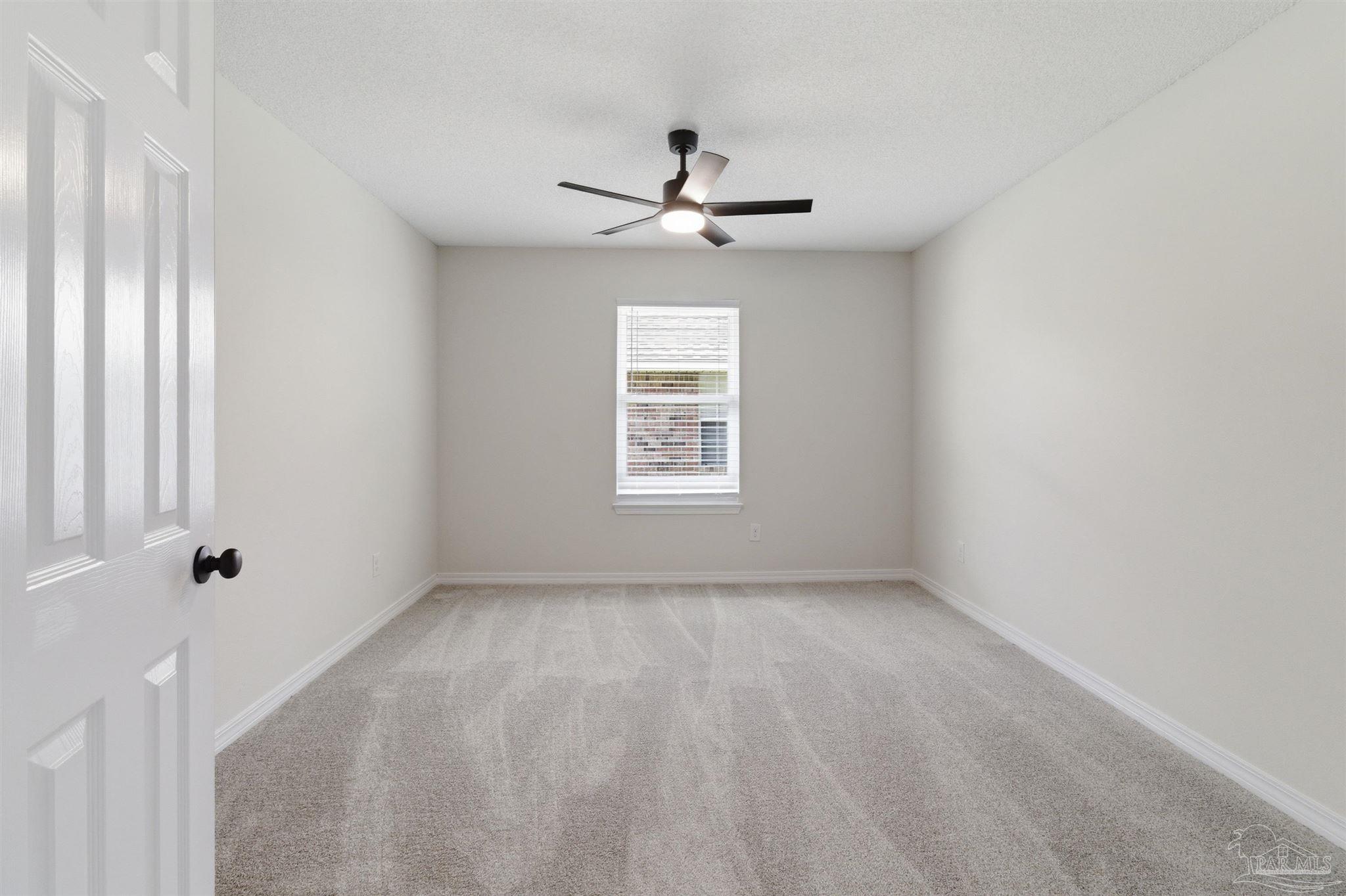 1866 Wareham Way Cantonment, FL 32533 - Photo 21 of 33 an empty room with windows and fan