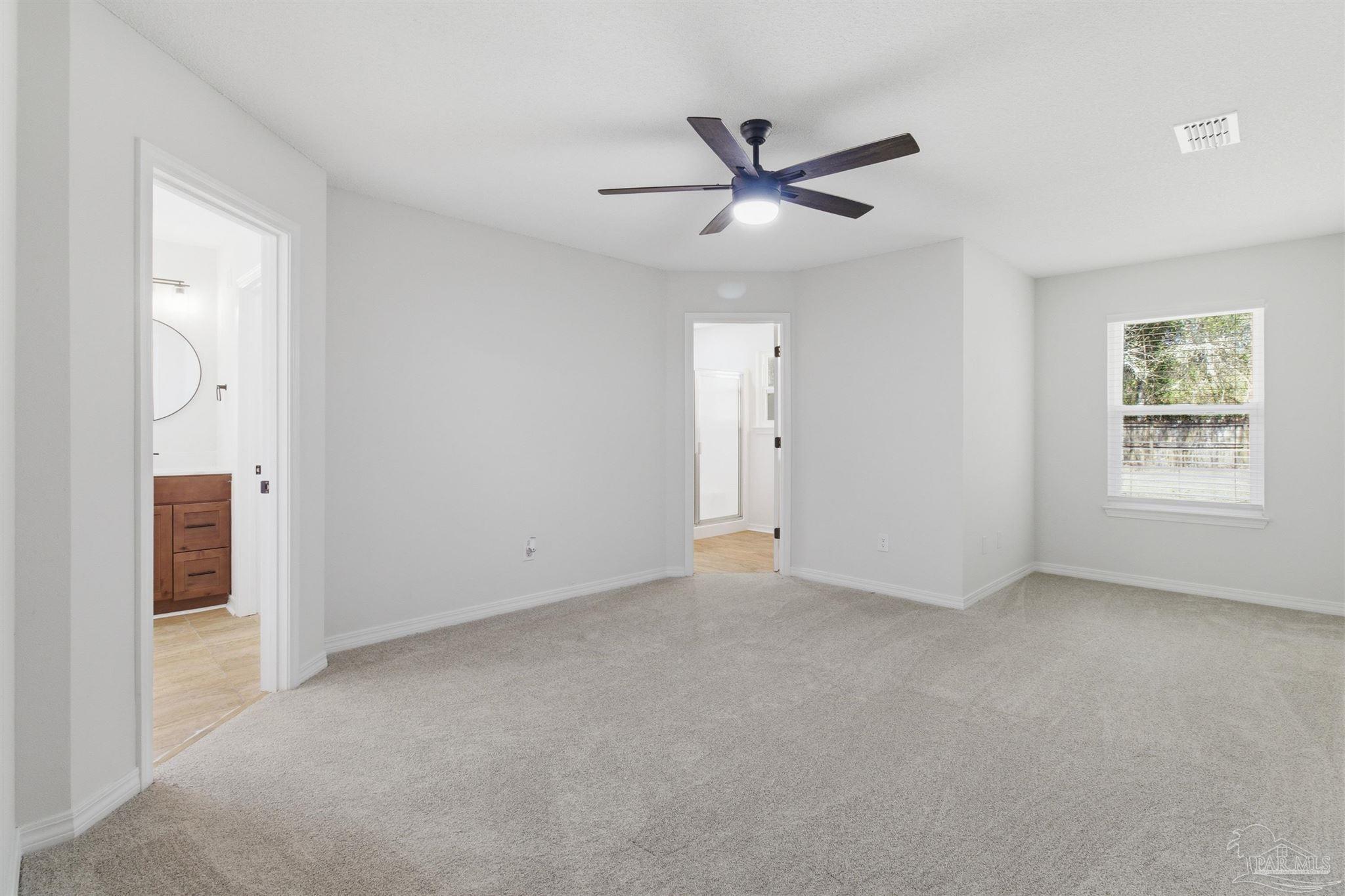 1866 Wareham Way Cantonment, FL 32533 - Photo 23 of 33 a view of a livingroom with a ceiling fan and window