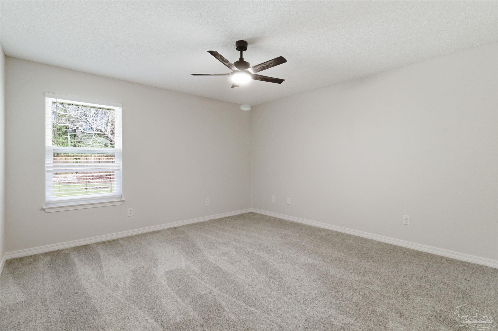 1866 Wareham Way Cantonment, FL 32533 - Photo 26 of 33 an empty room with a window and a fan