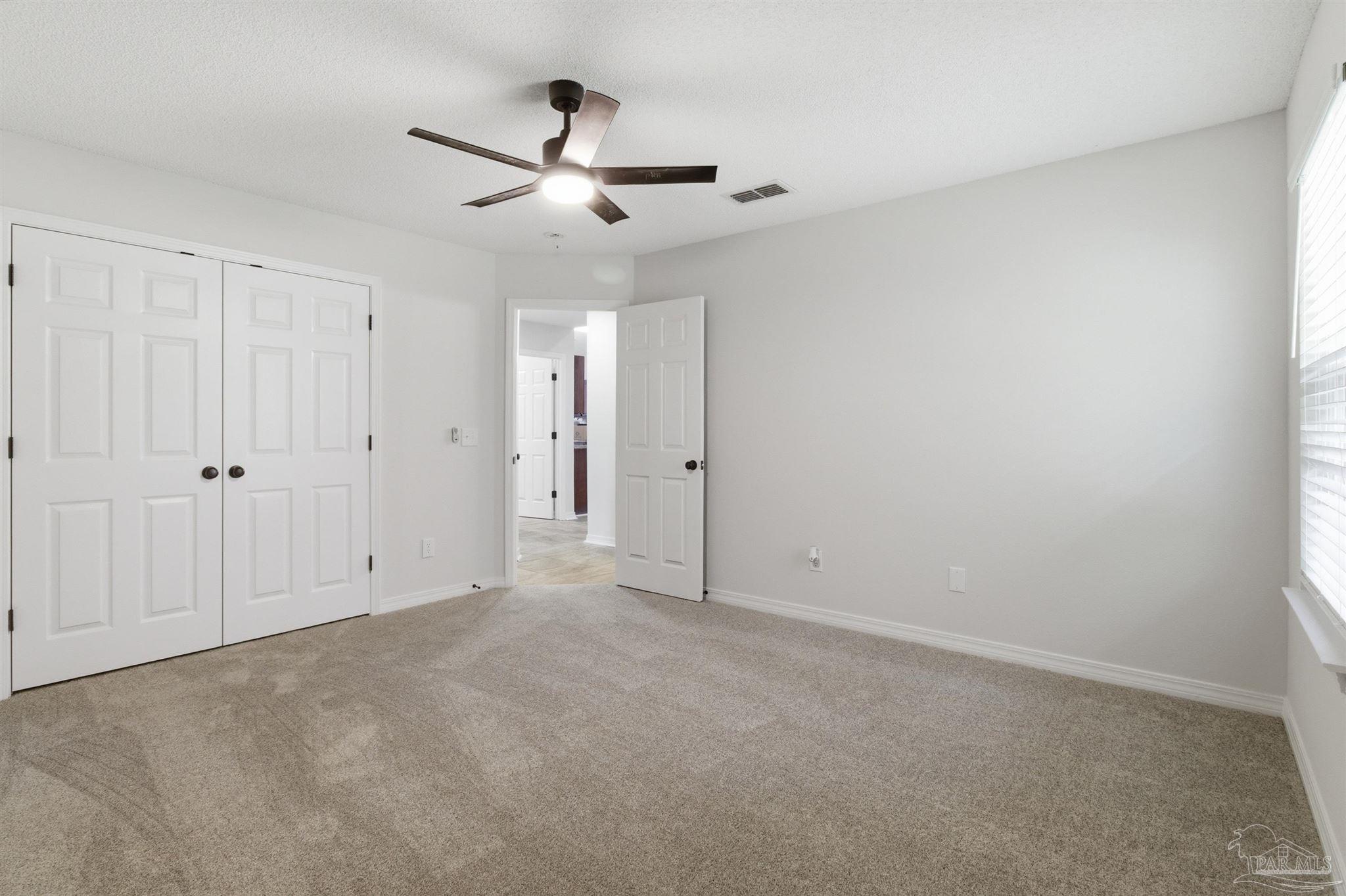 1866 Wareham Way Cantonment, FL 32533 - Photo 27 of 33 an empty room with chandelier fan
