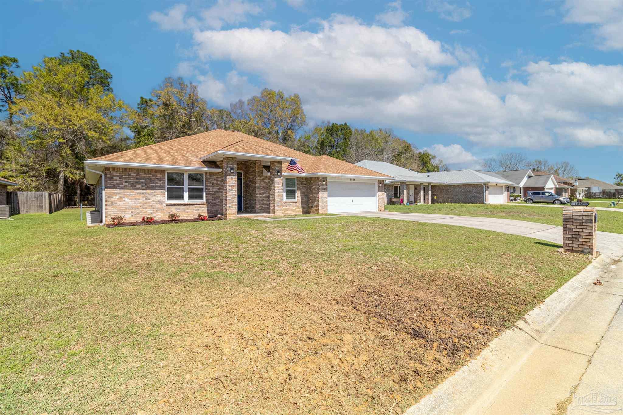 1866 Wareham Way Cantonment, FL 32533 - Photo 29 of 33 a view of a house with a big yard and large trees