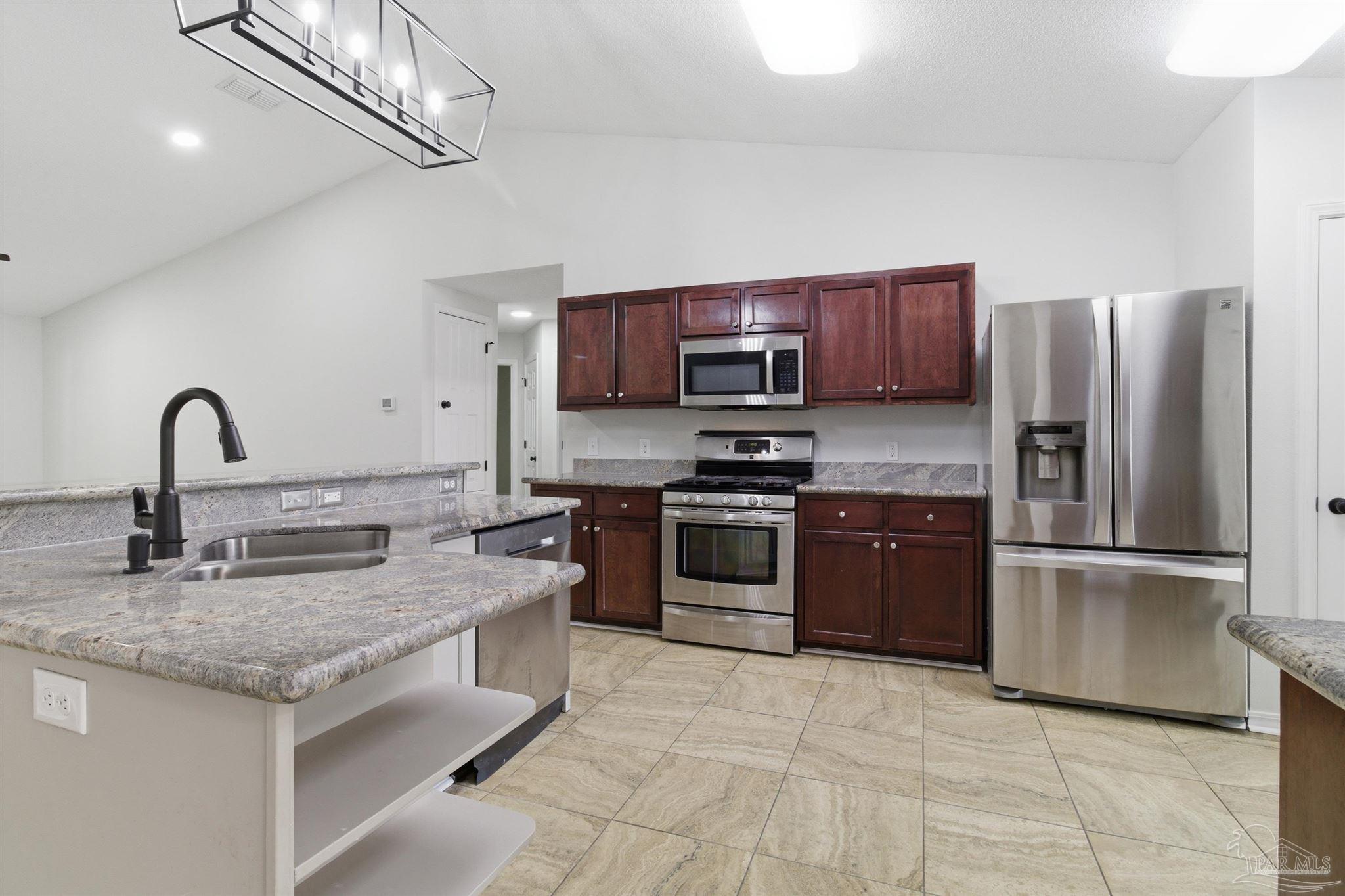 1866 Wareham Way Cantonment, FL 32533 - Photo 3 of 33 a kitchen with stainless steel appliances granite countertop a sink stove and refrigerator