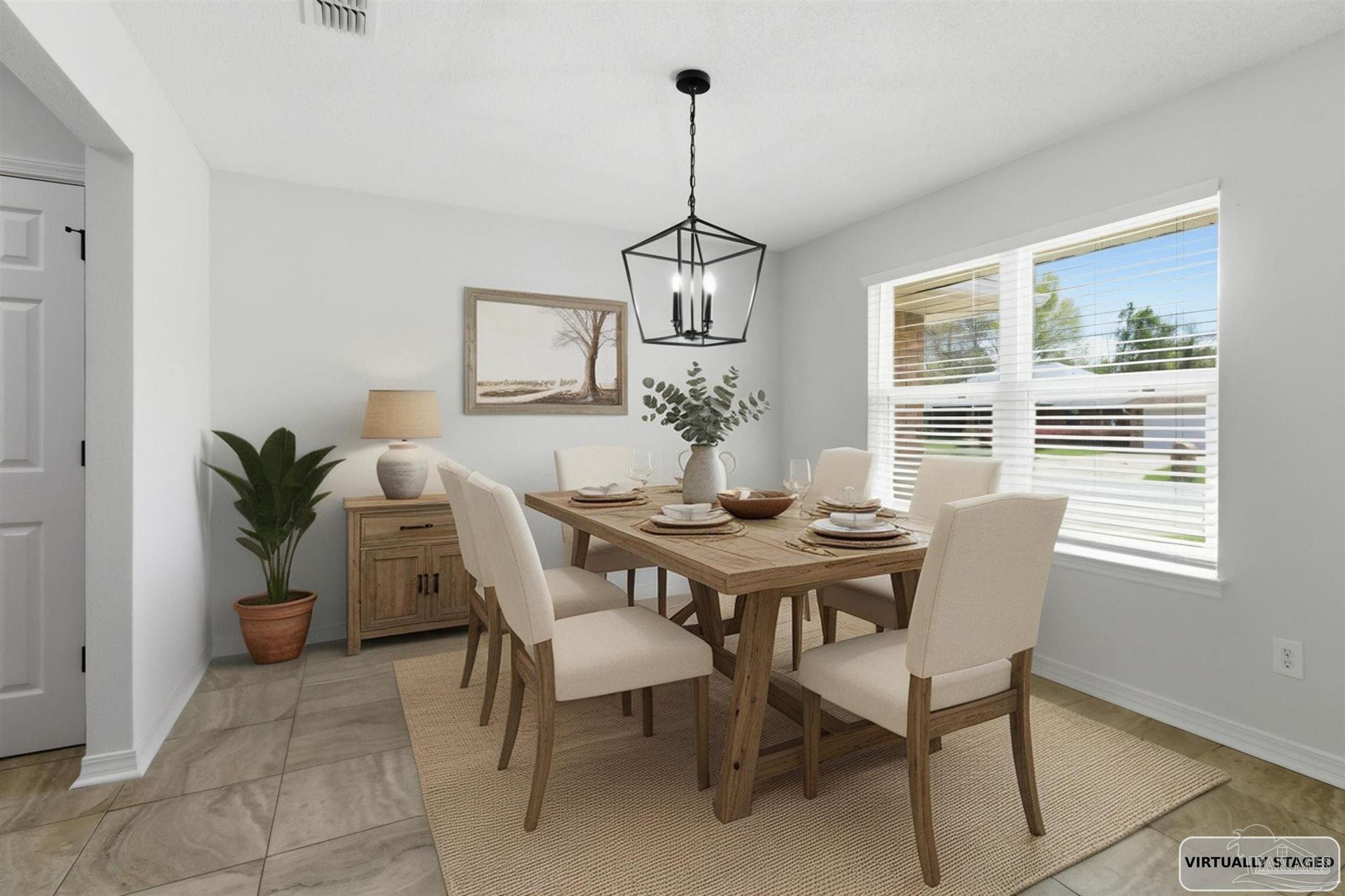 1866 Wareham Way Cantonment, FL 32533 - Photo 7 of 33 a dining room with furniture window and wooden floor