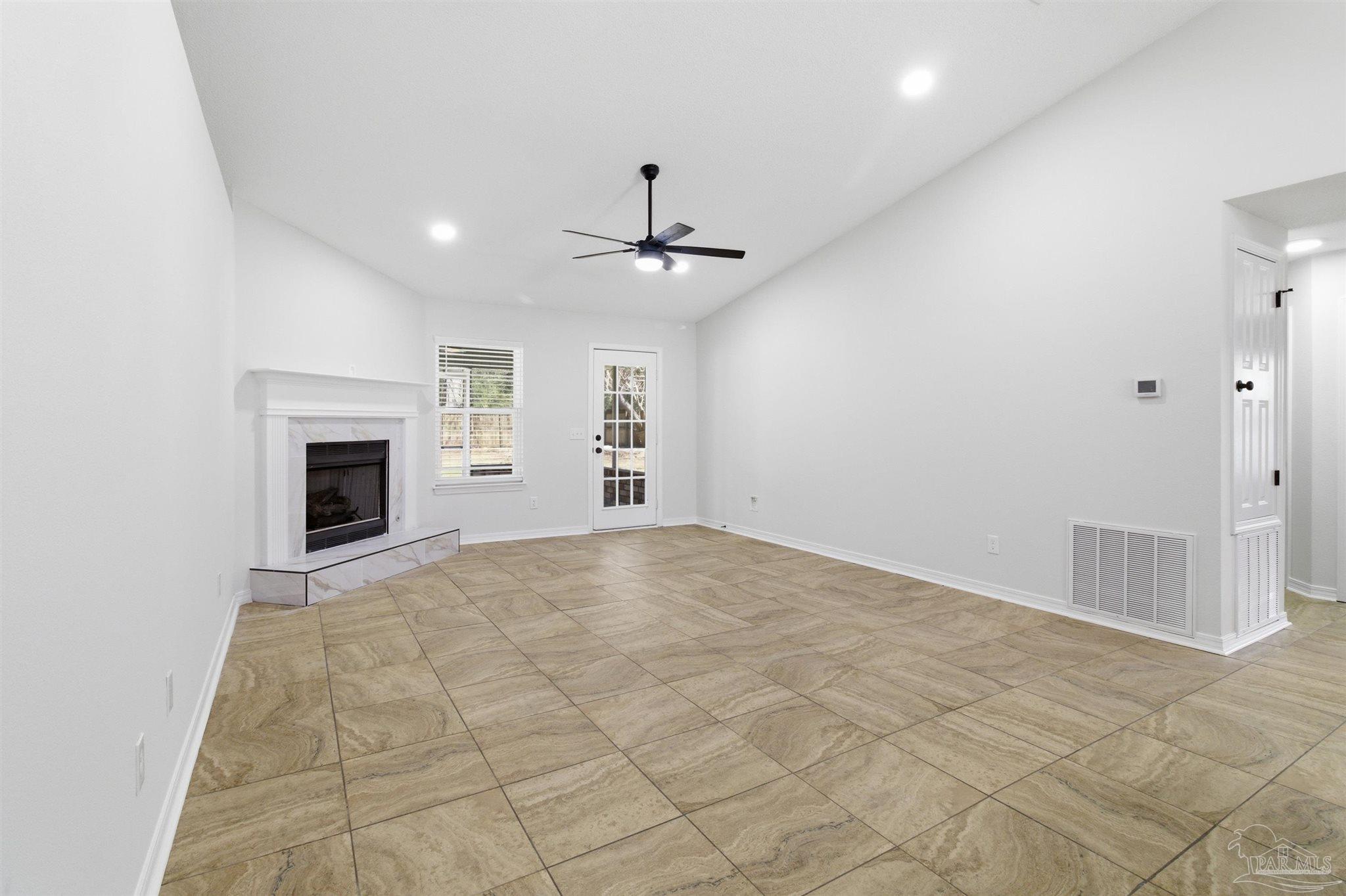 1866 Wareham Way Cantonment, FL 32533 - Photo 9 of 33 an empty room with fireplace and fan