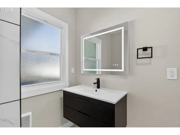 a bathroom with a sink and a mirror