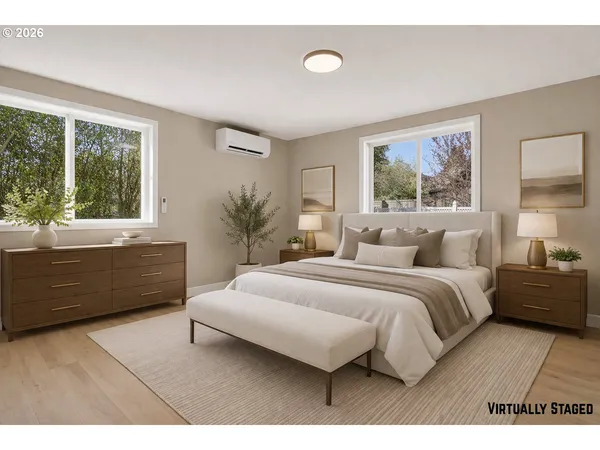 a bedroom with a large bed and a large window