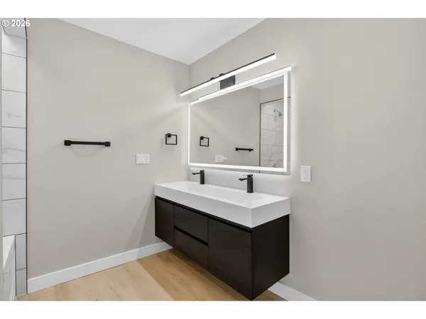 a bathroom with a sink vanity and a mirror
