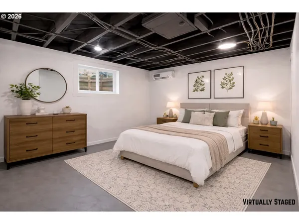 a bedroom with a bed a dresser with wooden floor