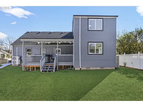 a view of a house with a yard and sitting area