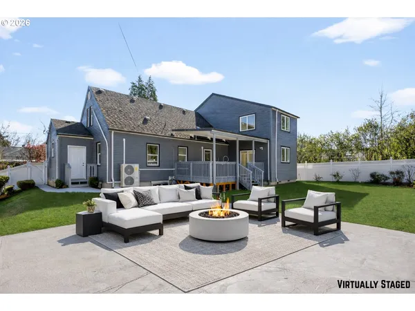 a view of a house with backyard sitting area and garden