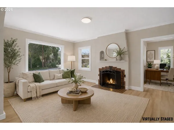 a living room with furniture a fireplace and a large mirror