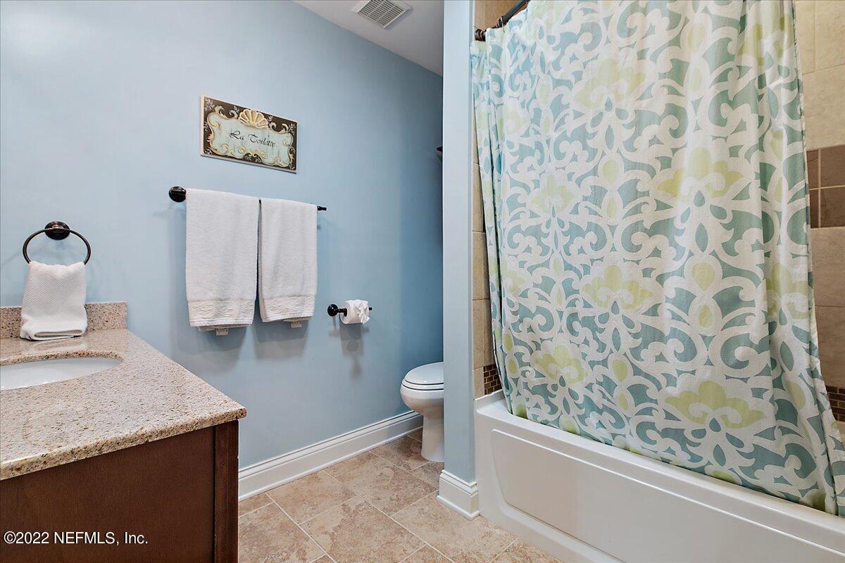 1921 Seminole Road Atlantic Beach, FL 32233 - Photo 11 of 27 a bathroom with a granite countertop sink toilet and shower